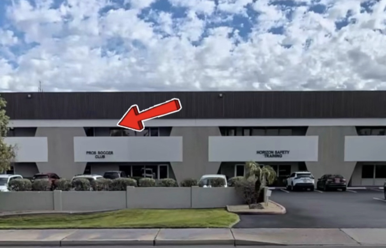 Exterior of the shop building with a red arrow pointing to Campside’s location